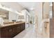 Spacious bathroom with double vanity, granite countertops, tiled floors, and ample storage space at 11510 92Nd Way, Largo, FL 33773