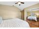 Bedroom with hardwood floors, a mirrored closet door, and a ceiling fan at 11510 92Nd Way, Largo, FL 33773
