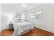 Bedroom featuring hardwood floors, a large window, and simple decor at 11510 92Nd Way, Largo, FL 33773