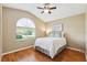 Bedroom with a vaulted ceiling, large window, and light-colored walls and hardwood floors at 11510 92Nd Way, Largo, FL 33773