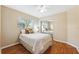 Cozy bedroom with hardwood floors, a large window, and mirrored closet doors at 11510 92Nd Way, Largo, FL 33773