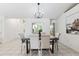Elegant dining room with a stylish table, upholstered chairs, decorative lighting, and a bright, open layout at 11510 92Nd Way, Largo, FL 33773