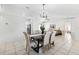 Bright dining area with modern light fixture, neutral color scheme, and open layout connected to the living room at 11510 92Nd Way, Largo, FL 33773