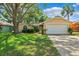 Charming home with a well-manicured lawn, mature trees, and a two-car garage at 11510 92Nd Way, Largo, FL 33773