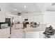 Bright and airy kitchen with an eat-in bar, white cabinets, stainless steel appliances, and tile flooring at 11510 92Nd Way, Largo, FL 33773