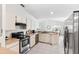 Well-lit kitchen with stainless steel appliances, light-colored cabinetry, and an open layout perfect for entertaining at 11510 92Nd Way, Largo, FL 33773