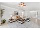 Spacious living room with vaulted ceiling, a ceiling fan, comfortable seating, and ample natural light at 11510 92Nd Way, Largo, FL 33773