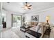 Inviting living room featuring neutral colors, plush seating, a ceiling fan, and sliding glass doors to the backyard at 11510 92Nd Way, Largo, FL 33773