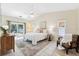 Serene bedroom featuring a ceiling fan, sliding glass doors, and a neutral color palette for a relaxing atmosphere at 11510 92Nd Way, Largo, FL 33773
