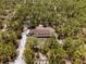 Expansive aerial view of the home nestled amongst lush greenery and mature trees at 12090 Thames Ave, Weeki Wachee, FL 34614