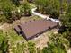 Expansive aerial view of home and acreage, featuring lush greenery and an RV/Camper parked on the property at 12090 Thames Ave, Weeki Wachee, FL 34614
