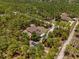 An aerial view of the houses, that features lush surrounding trees and multiple structures on the land at 12090 Thames Ave, Weeki Wachee, FL 34614