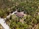 Aerial view of the home, highlighting its secluded setting amidst a dense canopy of trees at 12090 Thames Ave, Weeki Wachee, FL 34614
