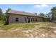 Expansive backyard featuring an outdoor fireplace, lush lawn, and a private patio at 12090 Thames Ave, Weeki Wachee, FL 34614