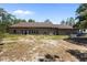 Expansive backyard with plenty of room for outdoor activities and a view of the home's exterior at 12090 Thames Ave, Weeki Wachee, FL 34614