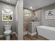 Updated bathroom featuring modern fixtures, a glass enclosed shower, and a soaking tub at 12090 Thames Ave, Weeki Wachee, FL 34614
