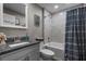 Charming bathroom featuring a granite-topped vanity, tub and shower combination, and classic fixtures at 12090 Thames Ave, Weeki Wachee, FL 34614