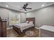 A cozy bedroom, furnished with a twin bed, features natural light streaming in from a window fitted with plantation shutters at 12090 Thames Ave, Weeki Wachee, FL 34614