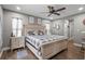 Comfortable bedroom showcasing a queen-size bed, two windows for natural lighting, and a cozy ambiance at 12090 Thames Ave, Weeki Wachee, FL 34614