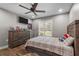 A cozy bedroom, furnished with a twin bed, features natural light streaming in from a window fitted with plantation shutters at 12090 Thames Ave, Weeki Wachee, FL 34614