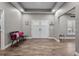 Inviting foyer with wood-look tile flooring, double doors, and elegant decor at 12090 Thames Ave, Weeki Wachee, FL 34614