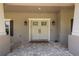 Close-up of the beautiful double front doors and porch with brick pavers and exterior sconces at 12090 Thames Ave, Weeki Wachee, FL 34614