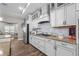 Well-appointed kitchen boasts stainless steel appliances, granite countertops, and subway tile backsplash at 12090 Thames Ave, Weeki Wachee, FL 34614