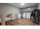 Functional laundry room with modern washer, dryer, ample storage cabinets, and durable flooring at 12090 Thames Ave, Weeki Wachee, FL 34614