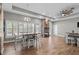 Open-concept living room with a fireplace, wood floors, and lots of natural light at 12090 Thames Ave, Weeki Wachee, FL 34614
