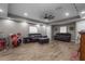 Spacious living room with hardwood floors, comfortable seating, a ceiling fan, and room for a drum set at 12090 Thames Ave, Weeki Wachee, FL 34614