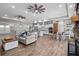 Open-concept living area with island kitchen, dining area, and comfortable seating at 12090 Thames Ave, Weeki Wachee, FL 34614