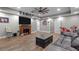 Cozy living room with a fireplace, wood floors, and entertainment center at 12090 Thames Ave, Weeki Wachee, FL 34614