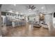 Spacious open-concept kitchen, dining, and living area with wood floors and stone fireplace at 12090 Thames Ave, Weeki Wachee, FL 34614