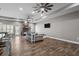 Spacious living room boasts hardwood floors, a stone fireplace, and abundant natural light, creating a comfortable atmosphere at 12090 Thames Ave, Weeki Wachee, FL 34614