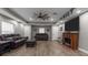 Cozy living room features a fireplace, hardwood floors, comfortable seating, and ample space for relaxation at 12090 Thames Ave, Weeki Wachee, FL 34614
