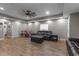 Spacious living room with hardwood floors, comfortable seating, a ceiling fan, and lots of room at 12090 Thames Ave, Weeki Wachee, FL 34614