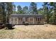 Tan shed with barn doors and barrel accents, adding rustic charm to the property at 12090 Thames Ave, Weeki Wachee, FL 34614