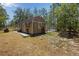 Well-maintained storage shed equipped with barn doors and a fenced enclosure at 12090 Thames Ave, Weeki Wachee, FL 34614