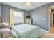 Comfortable bedroom featuring neutral paint, a large window, and a well-placed dresser for storage at 12838 Tallowood Dr, Riverview, FL 33579