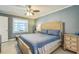 Serene bedroom features neutral walls, a large window, and a ceiling fan at 12838 Tallowood Dr, Riverview, FL 33579
