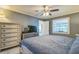 Relaxing bedroom features a window, a ceiling fan, and ample closet space at 12838 Tallowood Dr, Riverview, FL 33579