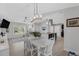 Open-concept dining and living area with modern lighting and kitchen view at 12838 Tallowood Dr, Riverview, FL 33579