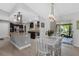 Open dining area with a modern table, chairs, and easy access to both the kitchen and outdoor patio at 12838 Tallowood Dr, Riverview, FL 33579