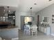 Open dining area with granite counters, stainless appliances, and sliding glass doors to the backyard at 12838 Tallowood Dr, Riverview, FL 33579