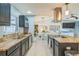 Bright kitchen with stainless appliances, granite counters, tile floors, and an open layout at 12838 Tallowood Dr, Riverview, FL 33579