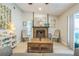 Living room view featuring a fireplace with a mantle, comfortable chairs, and natural light at 12838 Tallowood Dr, Riverview, FL 33579