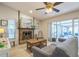 Comfortable living room with fireplace, sliding glass doors and plenty of natural light at 12838 Tallowood Dr, Riverview, FL 33579