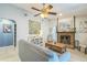 Relaxing living area featuring a stone fireplace, a comfortable sofa, and stylish decor at 12838 Tallowood Dr, Riverview, FL 33579