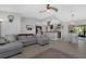 Open-concept living room features a large sectional sofa and a view of the kitchen and dining area at 12838 Tallowood Dr, Riverview, FL 33579