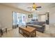 Cozy living room with sliding glass doors leading to an enclosed patio, complete with a coffee table at 12838 Tallowood Dr, Riverview, FL 33579